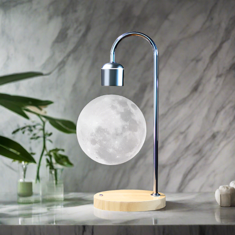 Levitating moon lamp with a wooden base and metallic arm, set on a marble surface, creating a modern and tranquil atmosphere.