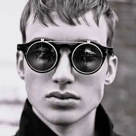 Close-up image of a man wearing "Mr. Who" Oldschool Fashion Sunglasses, showcasing the unique round flip-up clamshell design and bold s