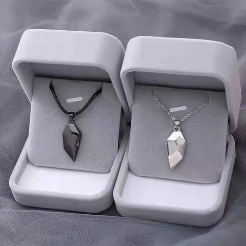 Pair of 'Broken Heart' Korean Fashion Necklaces featuring a magnetic heart pendant that symbolizes the connection between two lovers. Perfect for both men and women, available in stylish black and silver designs