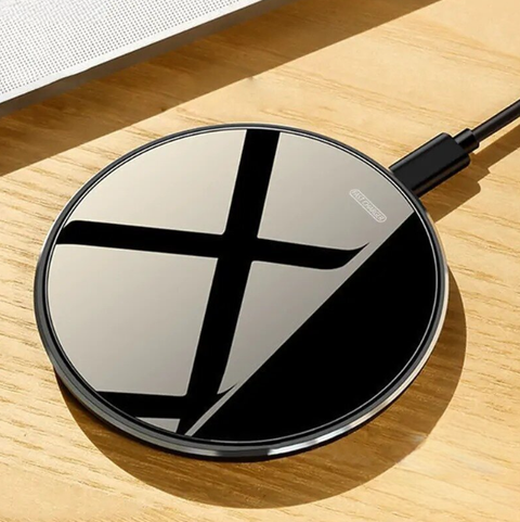 Wireless Charging Pad with a sleek, black design and fast charging capabilities for Qi-enabled devices, shown on a wooden desk