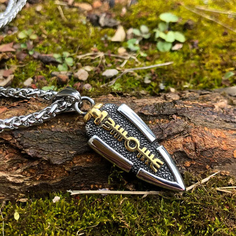 Valknut Gungnir Necklace featuring Odin's Spear with Rune Symbol and Ravens of Odin, adorned with a mesmerizing Labradorite gem, lying on a mossy surface.