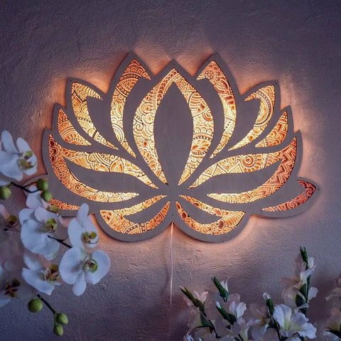 Eternal Blossom Art Wall Ornament featuring an intricately laser-cut lotus flower mandala design, emitting a serene glow on the wall, enhancing the ambiance of a room decorated with orchids.