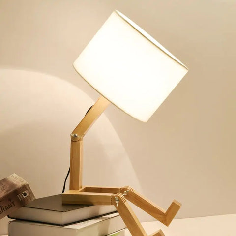 iRobot Shape Customizable Desk Lamp with a unique robot design, made from durable wood and fabric, adding a touch of fun and style to any room.