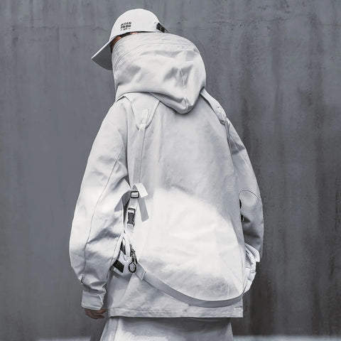 Person wearing the Urban Samurai High Collar Streetwear Jacket in white, featuring a unique high collar design, accessorized with a matching cap and shoulder bag against a concrete background.